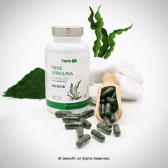 a bottle of green capsules next to a wooden spoon